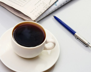 Cup of coffee near press.