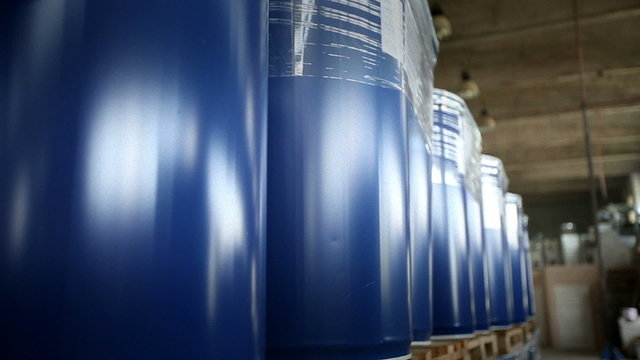 New blue barrels inside a storage warehouse slider shot