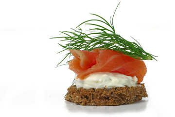 canape with salmon and dill garnish, isolated on white backgrou