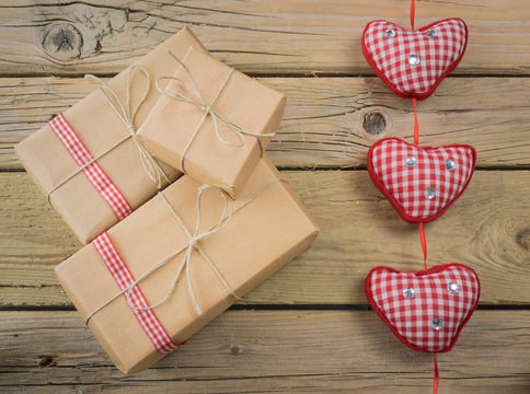 parcels wrapped in brown paper and string with red check ribbon