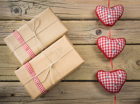 brown paper parcels with red check ribbon and hearts