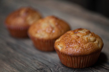 delicious homemade muffins over wooden board