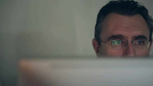 Middle-aged man working on a computer HD shot with slider