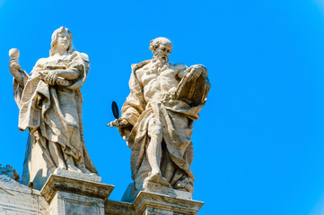 Fototapeta na wymiar Statues at the top of Basilica of Saint John Lateran in Rome, It