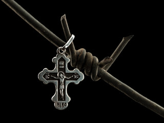 Christian cross on a barbed wire