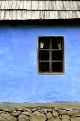 Traditional window from an old blue rustic house..