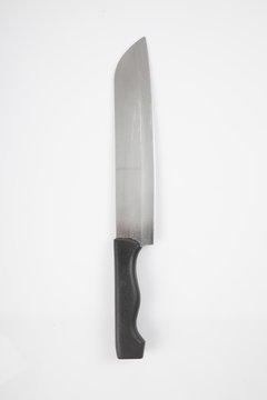 Stainless steel knife with black handle on white background