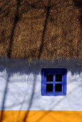 Traditional window close-up from an old blue rustic house..