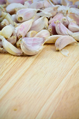 garlic cloves on wood cutting board