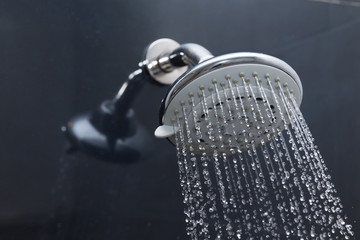 shower head in bathroom with water drops flowing