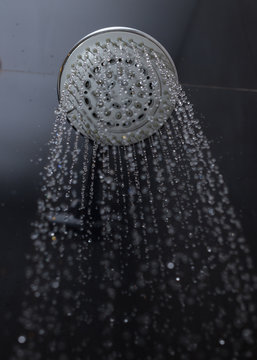 shower head with water drops flowing