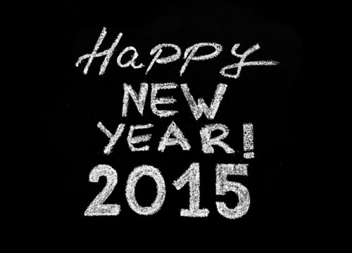 Happy new year 2015, hand writing with chalk on blackboard