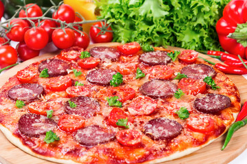 Pizza with tomatoes, salami and cheese