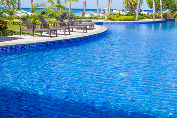 luxury pool in a hotel, resort leisure time, relaxing near the p