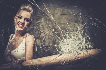 Punk girl breaking glass with a baseball bat - obrazy, fototapety, plakaty