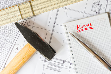 Planning home renovation, a hammer with a slide rule on the tabl
