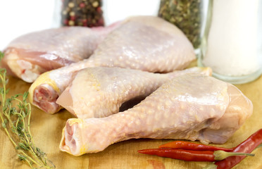 chicken legs on a wooden cutting board