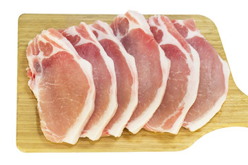 raw pork steaks on a cutting board