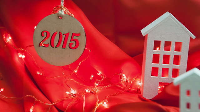 New Year 2015. Decorative composition homes on a red background.