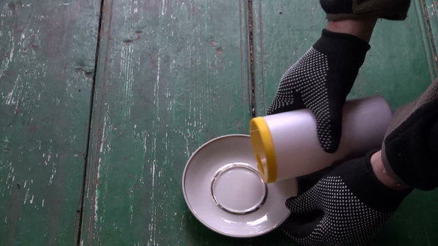 farmer opening new poison toxic bottle for pest rat mouse