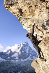 Rock Climber against blue sky - Stock Image - 73969983