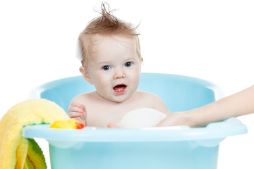 adorable baby taking bath in blue tub