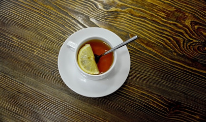 Cup of tea served with lemon. Shot made from above