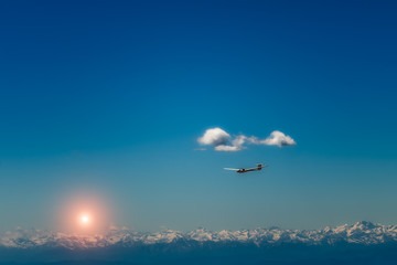 Fototapeta na wymiar glider flying over the Alps