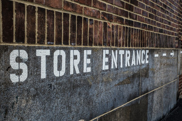 Store Entrance stenciled on building exterior