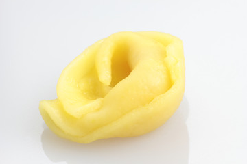One, freshly cooked tortellini on white background.