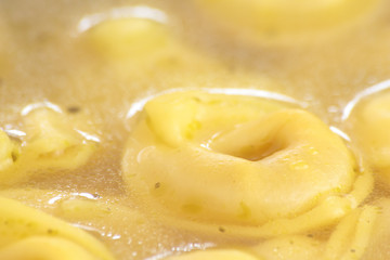 Tortellini diped and cooked in chicken broth.