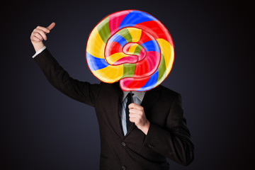 Businessman holding a lollipop