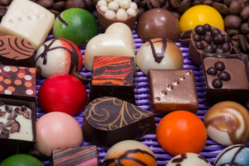 chocolate pralines and coffee beans in lavender basket