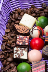 Obraz na płótnie Canvas chocolate pralines and coffee beans in lavender basket