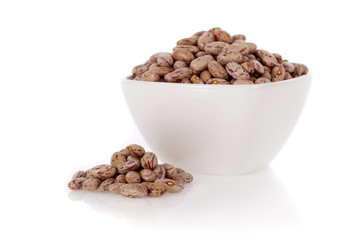 Pinto beans in a bowl isolated on a white background
