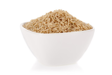 Brown rice in a bowl isolated on a white background