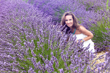 Beautiful girl smiling in a field of lavender