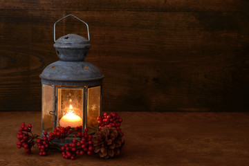 antique lantern with red berries