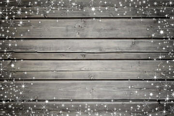 Wooden background with snow and stars