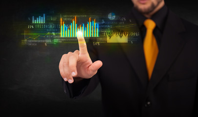 Young business person touching colorful charts and diagrams