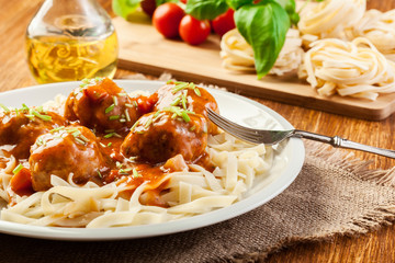 Pasta fettuccine and meatballs with tomato sauce