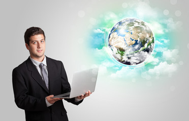 Young man with earth and cloud concept