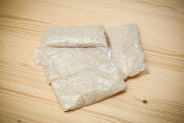 bags of rice on a wooden table