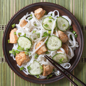 rice noodles with chicken and vegetables close up top view