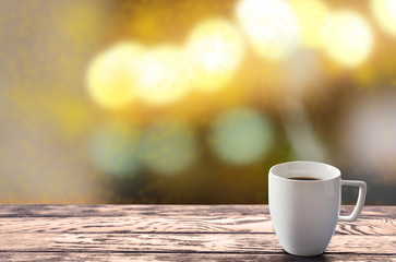 Cup of hot drink on bright background