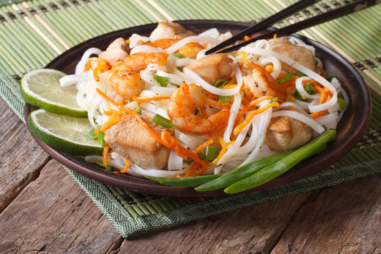 Rice noodles with seafood and chicken closeup. horizontal