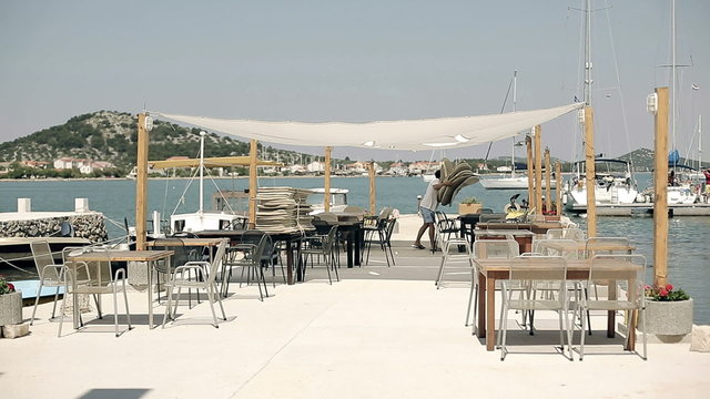 Owner of the restaurant and prepares restaurant tables
