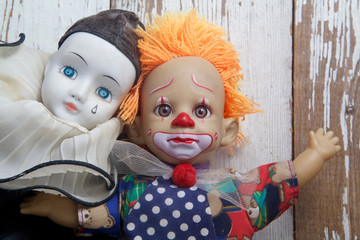 Sad old vintage dolls on wooden background