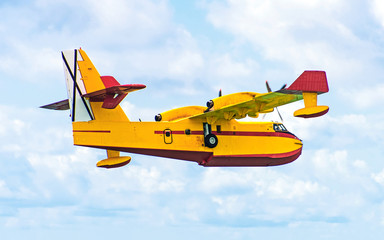 Fototapeta na wymiar Aerial firefighting. Aircraft preparing to collect sea water.