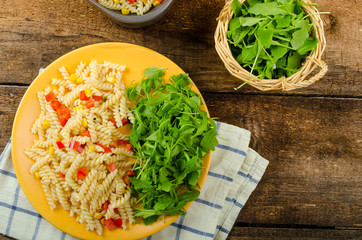 Pasta salad with vegetable and arugula salad with olive oil